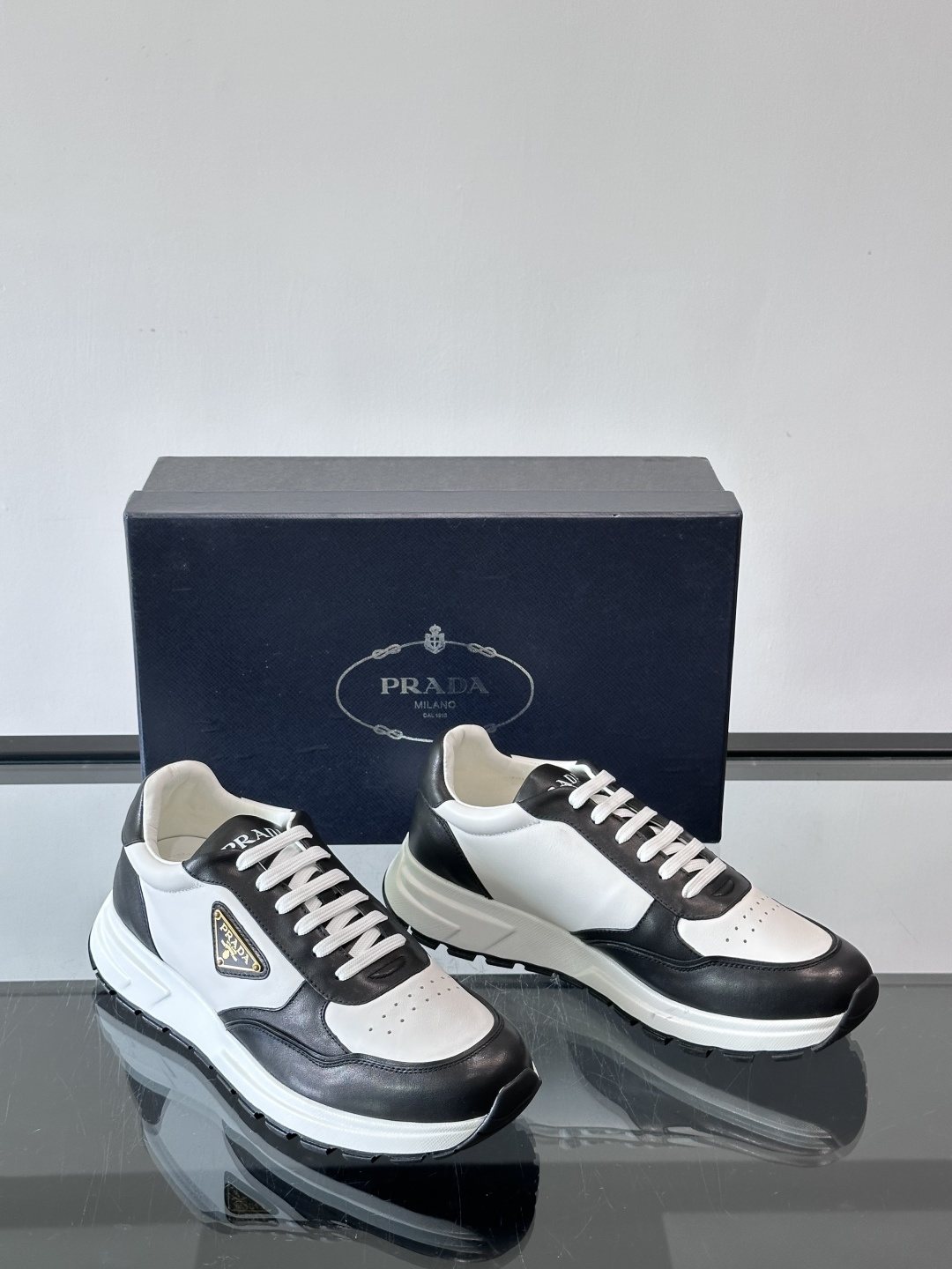 Prada Triangle Plaque Low-Top Sneakers — front
