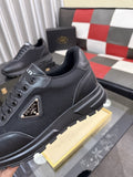 Prada Triangle Plaque Low-Top Sneakers — hero