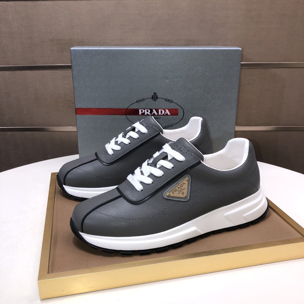 Prada Triangle Plaque Low-Top Sneakers — front